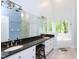The bathroom features double sink vanity, large mirror, and soaking tub beneath a window at 110 Blackford Ct, Durham, NC 27712