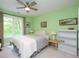 Comfortable bedroom with ceiling fan, large window, and ample natural light at 110 Blackford Ct, Durham, NC 27712