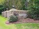 Stone community sign for Treyburn with manicured landscaping and mature trees at 110 Blackford Ct, Durham, NC 27712
