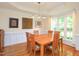 Bright dining room with wood table, wainscoting, and large windows at 110 Blackford Ct, Durham, NC 27712