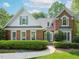 Well-maintained brick home with a manicured lawn, green door, and symmetrical window design at 110 Blackford Ct, Durham, NC 27712