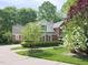 Charming brick home with a circular driveway and beautifully landscaped front yard at 110 Blackford Ct, Durham, NC 27712