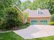 Brick house with two car garage and green garage doors at 110 Blackford Ct, Durham, NC 27712
