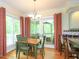 Bright eat-in kitchen featuring a breakfast area, hardwood floors, and French doors to a screened-in porch at 110 Blackford Ct, Durham, NC 27712