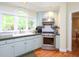 This bright kitchen features custom cabinets, stainless steel appliances and a large window at 110 Blackford Ct, Durham, NC 27712