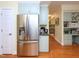 Kitchen boasts stainless steel refrigerator with wood flooring and easy access to hall at 110 Blackford Ct, Durham, NC 27712