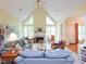 Bright living room features a vaulted ceiling, large windows, and fireplace at 110 Blackford Ct, Durham, NC 27712