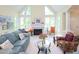 Bright living room featuring a vaulted ceiling, large windows, and cozy fireplace at 110 Blackford Ct, Durham, NC 27712