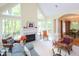 Bright living room features a vaulted ceiling, large windows, and fireplace at 110 Blackford Ct, Durham, NC 27712