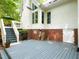 Multi-level wooden patio adjacent to two-story home with brick foundation at 110 Blackford Ct, Durham, NC 27712