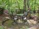 Outdoor patio seating area set among lush trees and landscaping at 110 Blackford Ct, Durham, NC 27712