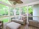Relaxing screened-in porch with ceiling fan, wicker furniture, and serene backyard views at 110 Blackford Ct, Durham, NC 27712