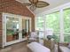 Cozy screened-in porch with brick accent wall, plush seating, and views of the outdoors at 110 Blackford Ct, Durham, NC 27712