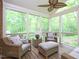 Inviting screened-in porch with comfortable seating, natural light, and wooded views at 110 Blackford Ct, Durham, NC 27712