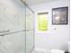 Modern glass shower with sleek tile work and a view of the outdoors at 110 Blackford Ct, Durham, NC 27712