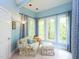 Bright sitting room has a large window and comfortable chair and ottoman at 110 Blackford Ct, Durham, NC 27712