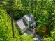 Aerial view of the home surrounded by lush greenery and mature trees, providing a sense of privacy at 1166 Nc Highway 87 N, Pittsboro, NC 27312