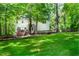 The backyard has a deck, patio seating, hammock and large green lawn at 1166 Nc Highway 87 N, Pittsboro, NC 27312