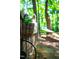 Lush backyard featuring a bicycle planter on the fence with a hammock in the distance at 1166 Nc Highway 87 N, Pittsboro, NC 27312