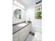 Bathroom featuring single sink, decorative wallpaper and mirror, toilet, and window at 1166 Nc Highway 87 N, Pittsboro, NC 27312