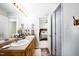 Bathroom featuring double sinks and view into bedroom, with access door slightly ajar at 1166 Nc Highway 87 N, Pittsboro, NC 27312