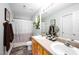 Bathroom features double sinks, a toilet, and shower with curtain and window at 1166 Nc Highway 87 N, Pittsboro, NC 27312