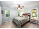 Bright bedroom with hardwood bedframe and green patterned comforter, and plenty of natural light at 1166 Nc Highway 87 N, Pittsboro, NC 27312