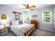 The bedroom has many windows for natural light and a ceiling fan at 1166 Nc Highway 87 N, Pittsboro, NC 27312