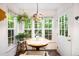 Charming breakfast nook with a round table, bright windows, and stylish Tiffany-style lighting at 1166 Nc Highway 87 N, Pittsboro, NC 27312