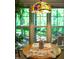 Cozy breakfast nook with large windows offering serene views of the surrounding trees at 1166 Nc Highway 87 N, Pittsboro, NC 27312