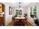 Bright dining room with hardwood floors, a round wood table, and beautiful windows at 1166 Nc Highway 87 N, Pittsboro, NC 27312