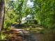 Charming home with a 2-car garage, covered porch and a long driveway at 1166 Nc Highway 87 N, Pittsboro, NC 27312