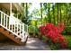 Landscaped stairs leading to the front porch, accented by lush red azaleas at 1166 Nc Highway 87 N, Pittsboro, NC 27312