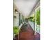 Relaxing front porch with rocking chairs, hanging plants, and classic white railing for a comfortable outdoor retreat at 1166 Nc Highway 87 N, Pittsboro, NC 27312