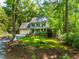 Charming two-story home with a well-manicured lawn, surrounded by mature trees providing shade at 1166 Nc Highway 87 N, Pittsboro, NC 27312