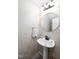 Stylish powder room with elegant wallpaper, pedestal sink, and modern fixtures at 1166 Nc Highway 87 N, Pittsboro, NC 27312