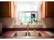 Bright kitchen sink with a window view and room for plants at 1166 Nc Highway 87 N, Pittsboro, NC 27312