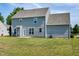Two story home, showcasing the well-maintained yard, patio, and neutral siding at 120 Shore Pine Dr, Youngsville, NC 27596