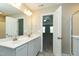 Bathroom with double sinks, white cabinets and a view into the bedroom at 120 Shore Pine Dr, Youngsville, NC 27596