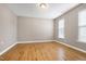 Bedroom with hardwood floors and two windows, providing ample natural light at 120 Shore Pine Dr, Youngsville, NC 27596