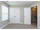 Bedroom with neutral walls, carpet, and double closets near the entrance at 120 Shore Pine Dr, Youngsville, NC 27596