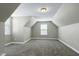 Bright, carpeted room with sloped ceilings and natural light from a window at 120 Shore Pine Dr, Youngsville, NC 27596