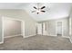 Large bedroom with vaulted ceiling, ceiling fan, and doorways to an ensuite bathroom and walk-in closet at 120 Shore Pine Dr, Youngsville, NC 27596