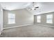 Spacious bedroom featuring vaulted ceiling, fan, neutral carpet, and lots of natural light at 120 Shore Pine Dr, Youngsville, NC 27596