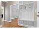 Entryway featuring wood floors, a built-in hall tree, and an open doorway to the dining room at 120 Shore Pine Dr, Youngsville, NC 27596