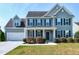 Charming two-story home featuring well-maintained landscaping, a covered porch, and an attached two-car garage at 120 Shore Pine Dr, Youngsville, NC 27596