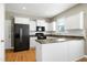 Modern kitchen with white cabinets, updated appliances, and a breakfast bar at 120 Shore Pine Dr, Youngsville, NC 27596