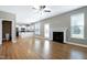 Bright living room with hardwood floors, ceiling fan, and a cozy fireplace at 120 Shore Pine Dr, Youngsville, NC 27596