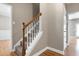 Staircase with carpet, hardwood floors and white railing at 120 Shore Pine Dr, Youngsville, NC 27596