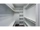 Organized walk-in closet with shelves, rods, and carpeted flooring at 120 Shore Pine Dr, Youngsville, NC 27596
